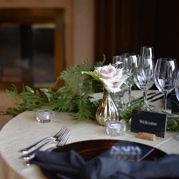Photo of styled table with fresh garland and florals for wine dinner in the Oak Room.