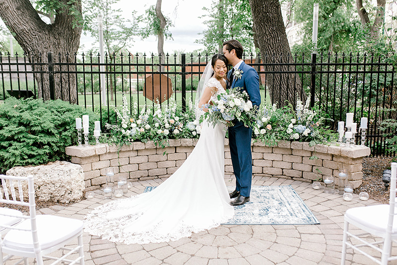 Wedding couple in Bonnycastle Garden (light blue and white floral ceremony). Casey Nolin Photography