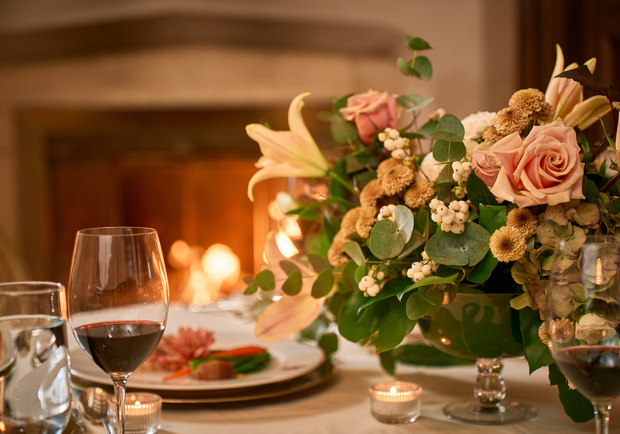 Red wine on a table in front of the Oak Room fireplace.